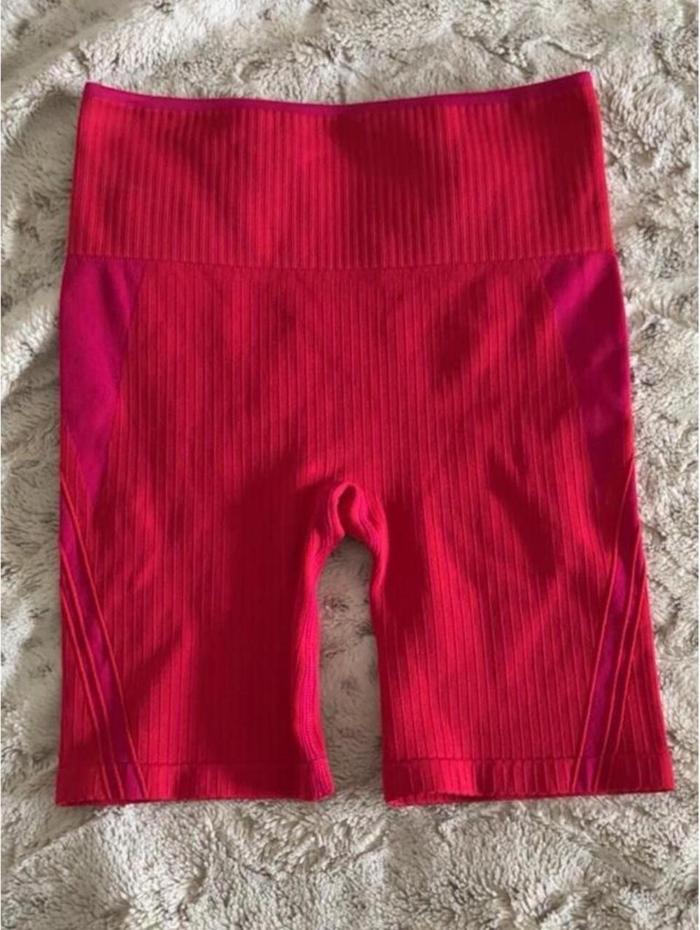 ryka fuchsia pink and red high-waisted bike shorts with vertical ribbed texture